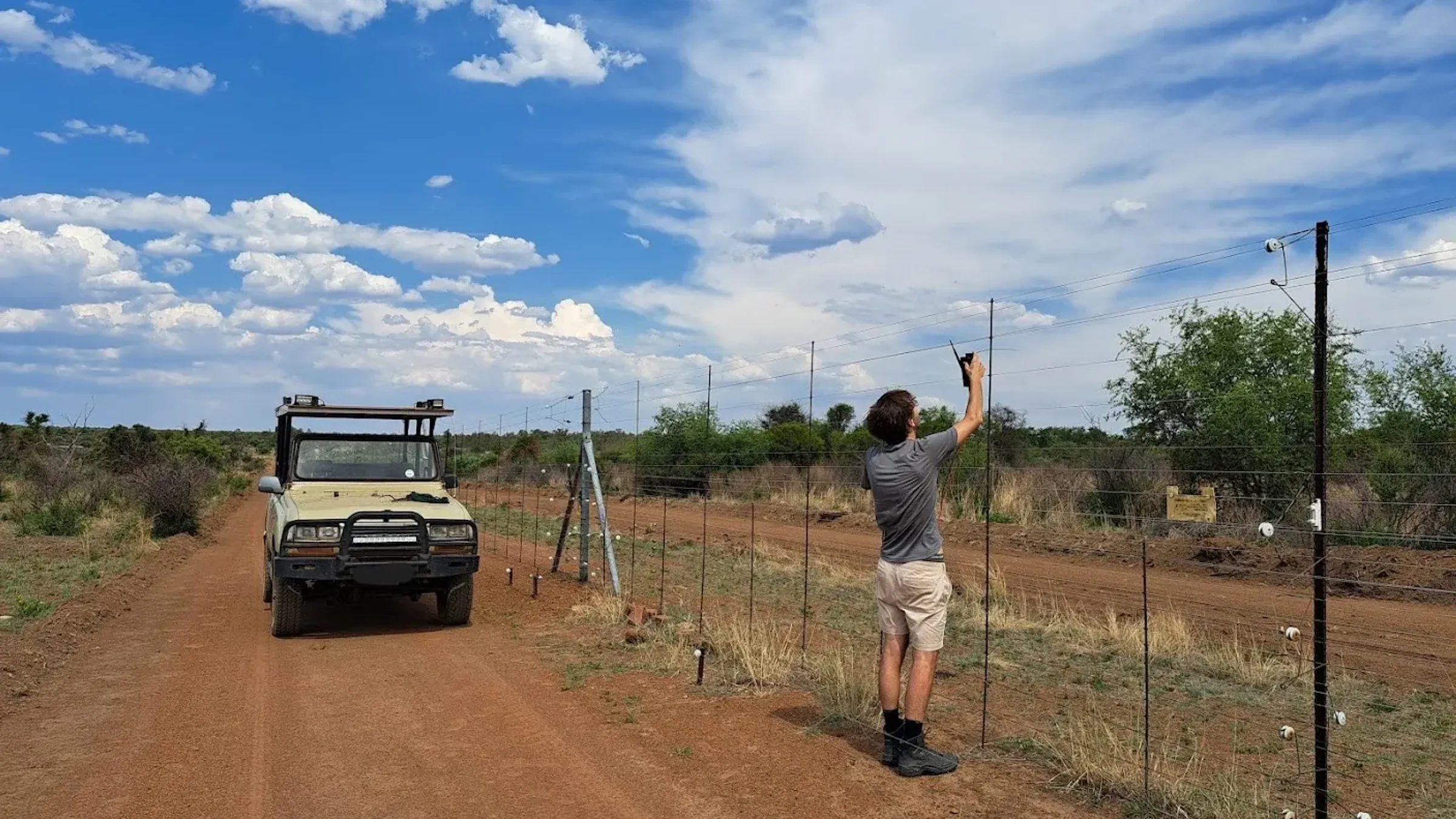 Field technician deploying Safora fence monitoring equipment on an electric fence